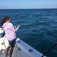 Fighting Against a Brown Trout Onboard the Crabby